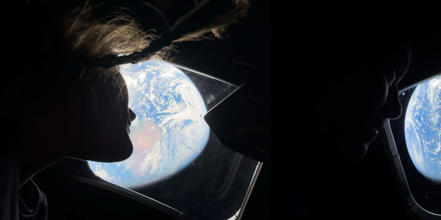 Uzay aracının penceresinden Dünya'ya bakan bir astronotun karanlıkta silueti.